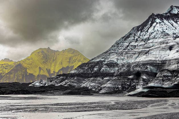 Creative Highlights World Contrast of black volcanic plains and moss-covered peaks near Katla glacier in Iceland during glacial melt season Copyright: LauraxGrier 1218-2225