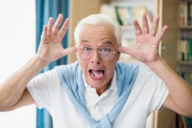 Senior man making faces Senior man making faces in a retirement home, model released, , property released, Cape Town, South Africa, 02.03.2016, 750849.jpg, home, senior, sheltered, daycare, accommodation, leisure, lifestyle, retirement, residential, retired, geriatric, nursing home, retirement home, health, senior citizen, clinic, retiree, hospice, patient, healthcare, medicare, healthcare and medicine, aged, sitting, cupboard, books, curtain, happy, smiling, cheerful, grimaces, making, faces, wearing, glasses 50s, Mature Adult, Man, Male, Caucasian, 55-59 Years, Mature Men, Caucasian Ethnicity