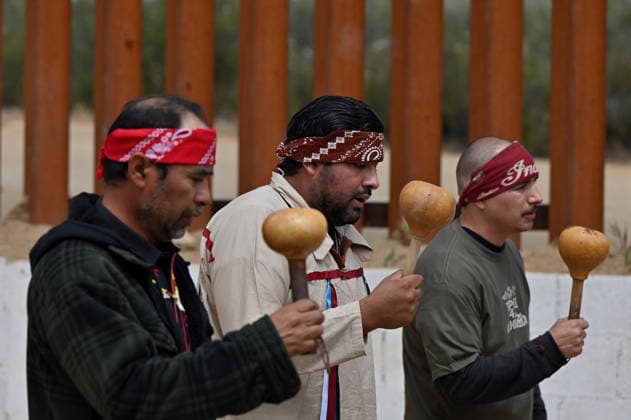 April 12, 2026, Tecate, Baja California, Mexico: Members of native communities, mainly Kumeyaay native group, during a â€oeceremony†rally against the destruction of the Kuchamaa Mountain left by the construction of a new border wall at the US-Mexico Border in Tecate, Baja California, Mexico on Sunday, April 12, 2026. The Kuchamaa Mountain is considered a sacred site by native groups living in both sides of the border. Tecate Mexico - ZUMAm180 20260412_zip_m180_006 Copyright: xCarlosxA.xMorenox