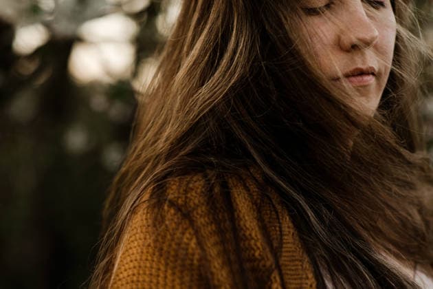 Close up of a woman with long brown hair with her eyes closed outdoors Calgary, Alberta, Canada CR_AMST26041009-1892963-01 ,model released, Symbolfoto ,property released