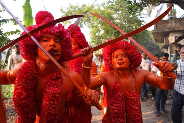 April 13, 2026, Munshigonj, Dhaka, Bangladesh: Munshiganj, Bangladesh, April 13, 2026. A centuries-old traditional Kach dance was held in Abdullahpur area of Tongibari upazila in Munshiganj, marking the eve of Chaitra Sankranti...Locally known as Lal Kach or Dhol Kach, the ritual is a century-old folk tradition observed annually on the day before Chaitra Sankranti, holding deep religious significance for Hindu devotees...From early morning, thousands of devotees and visitors gathered at the venue to take part in the celebrations, creating a vibrant and festive atmosphere...Participants, with their bodies covered in red paint, performed rhythmic dances to the beats of traditional drums as an offering to the deity. The ritualistic performance  - ZUMAk185 20260413_zip_k185_095 Copyright: xRubelxKarmakerx