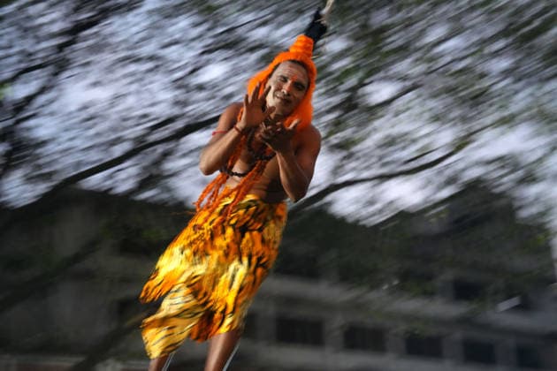 April 14, 2026, Dhaka, Dhaka, Bangladesh: A Hindu devotee is suspended mid-air during the Charak Puja ritual in Shakhari Bazar, Dhaka, Bangladesh. As part of the traditional ceremony dedicated to Lord Shiva, sannyasis are hooked through the skin of their backs and spun from a wooden structure, performing acts of physical endurance in a display of faith and devotion. Dhaka Bangladesh - ZUMAk174 20260414_zip_k174_009 Copyright: xSyedxMahabubulxKaderx
