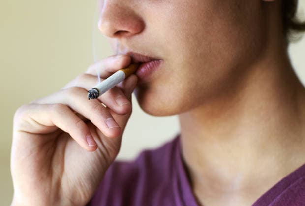 Closeup of a person taking a drag from a cigarette. (License=RF) ,model released, Symbolfoto  Copyright: xZoonar.com YurixArcursx 18329373 ,model released, Symbolfoto ,property released
