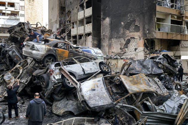 April 14, 2026, Beirut, Lebanon: Lebanese salvage belongings from a their destroyed car seated on top of scores burned vehicles at the site of an Israeli air strike in Beirut. Lebanon and Israel are holding their first direct diplomatic talks in more than 30 years. The talks are aimed at preparing negotiations to resolve Israel s conflict with pro-Iranian Hezbollah. Hezbollah leader Naim Qassem urged Lebanon to cancel the planned meeting with Israel, reiterating his group s rejection of direct negotiations with its foe. Beirut Lebanon  - ZUMAn313 20260414_zip_n313_010 Copyright: xMarwanxNaamanix