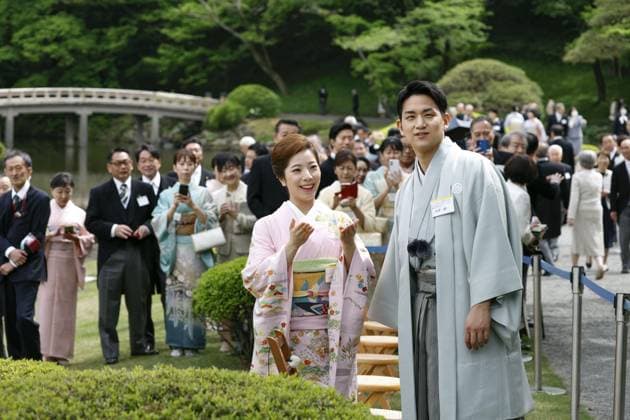 Japanese imperial garden party Japanese figure skating pair Riku Miura (front, L) and Ryuichi Kihara are pictured at the spring imperial garden party at the Akasaka Imperial Gardens in Tokyo on April 17, 2026. The pair, who won Japan s first pairs gold medal at the 2026 Milan Cortina Olympics, announced their retirement from competition the same day.  A14AA0005465593P