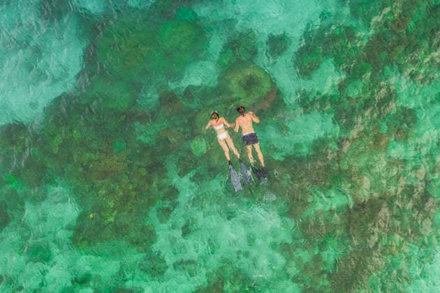 High angle shot of an unrecognizable couple swimming in the waters of Raja Ampat. (License=RF) ,model released, Symbolfoto  Copyright: xZoonar.com YurixArcursxpeopleimages.comx 18555967 ,model released, Symbolfoto ,property released