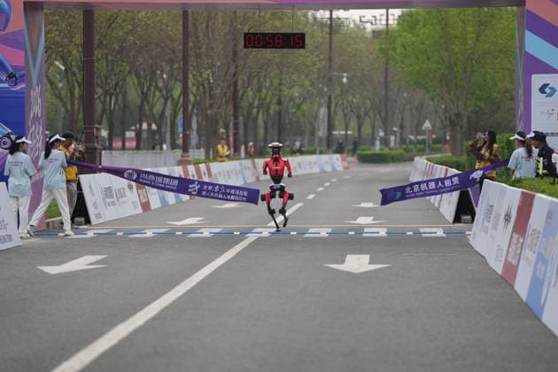 BEIJING, CHINA - APRIL 19: Honor s autonomously navigated Lightning crosses the finish line at the 2026 Beijing E-Town Humanoid Robot Half-marathon on April 19, 2026 in Beijing, China. A remotely controlled Lightning robot from one Honor team was the first to cross the finish line, clocking 48 minutes and 19 seconds, according to China Media Group (CMG). Under the event s weighted scoring rules, however, an autonomous-navigation Lightning robot from another Honor team won the title with a net time of 50 minutes and 26 seconds.  Copyright: xVCGx 111635790975