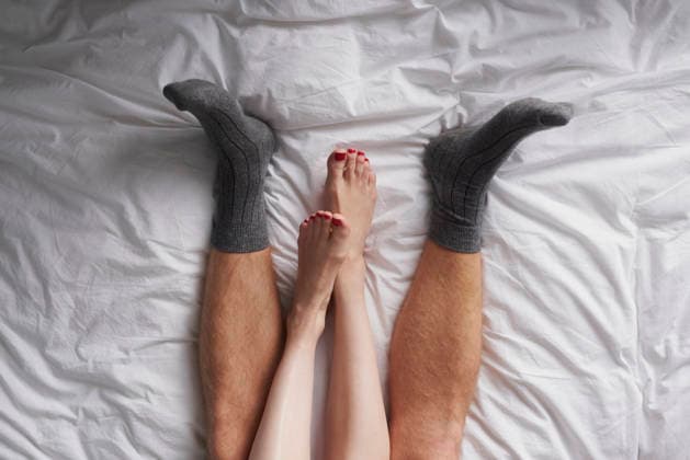 Closeup of the legs of a couple lying in bed affectionately cuddling. (License=RF) ,model released, Symbolfoto  Copyright: xZoonar.com KasperxRavlox 18806772 ,model released, Symbolfoto ,property released