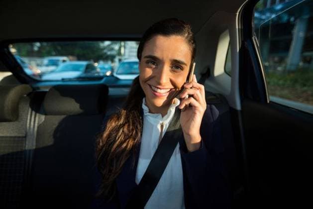 Business executive talking on mobile phone in car Portrait of business executive talking on mobile phone while traveling in car, model released, , property released, Cape Town, South Africa, 05.10.2016, 922316.jpg, real life, authentic, executive, associate, businesswoman, profession, professional, expertise, skill, corporate, manager, well dressed, modern, smart, sitting, looking, smiling, happy, cheerful, holding, traveling, seat, backseat, seatbelt, safety, window, glass, taxi, car, beautiful, pretty, stylish, transport, transportation, lifestyle, smartphone, mobile phone, cellphone, phone, wireless technology, communication, connection, talking, conversation, interacting, speaking, calling, on the phone, phoning, phone call