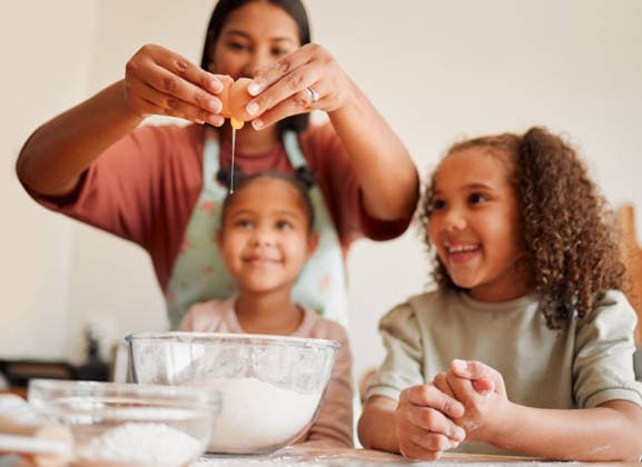 Females only, happy mixed race family of three cooking in a messy kitchen together. Loving black single parent bonding with her daughters while teaching them domestic skills at home. (License=RF) ,model released, Symbolfoto  Copyright: xZoonar.com YurixArcursxpeopleimages.comx 18806912 ,model released, Symbolfoto ,property released