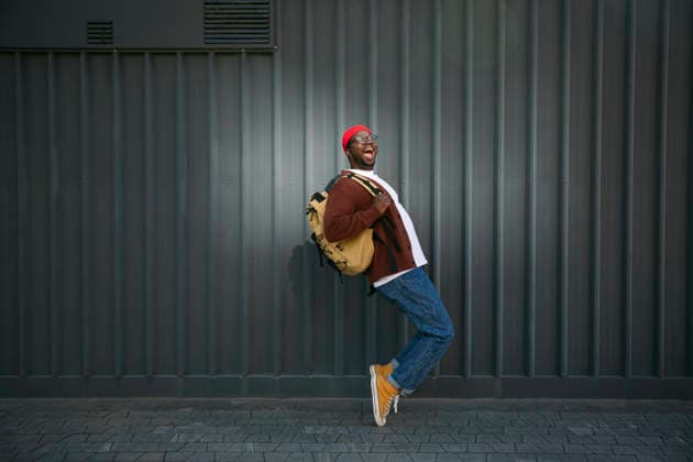 Smiling man in casual clothes dancing outdoors against urban wall model released, Symbolfoto, FLMZF01260