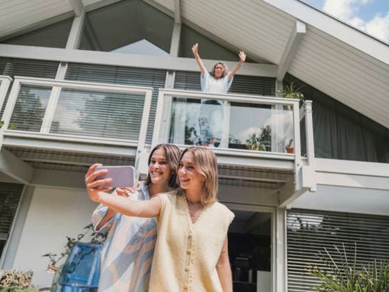 Mother and daughters taking selfie together outside modern house model released, Symbolfoto property released, MFF09895