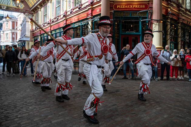 April 23, 2026, London, United Kingdom: The Ewell St Mary s Morris Men perform in Leadenhall Market in the City of London on St George s Day. The Ewell St. Mary s Morris Men performed at Leadenhall Market to mark 2026 St George s Day. The group carried out traditional Morris dances with bells, sticks, and handkerchiefs, accompanied by live music. Shoppers and visitors stopped to watch, as the performance brought a piece of English folk tradition into the City of London during the lunchtime period. London United Kingdom - ZUMAs197 20260423_aaa_s197_046 Copyright: xJamesxWilloughbyx
