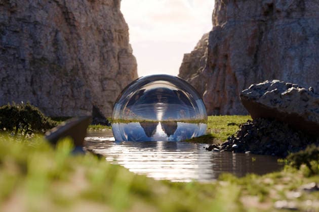Surreal 3D glass sphere reflecting rocky landscape in water, JPSF01873