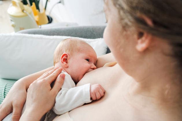 Mother breastfeeding her newborn baby indoors model released, Symbolfoto property released, NSTF00619