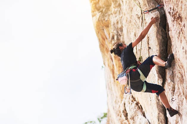 Dont stop until you reach the top. a young rock climber scaling a cliff face (License=RF) ,model released, Symbolfoto  Copyright: xZoonar.com YurixArcursx 19023063 ,model released, Symbolfoto ,property released