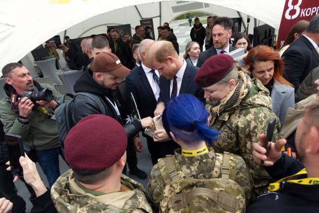 Prince Harry (C), The Duke of Sussex, signs a book while meeting Ukrainian soldiers and veterans at one of the interactive locations during the Invictus Games Ukraine Forum, dedicated to the 10th anniversary of the Invictus Games movement in Ukraine, at the National Museum of the History of Ukraine in WWII Memorial Complex, Kyiv, Ukraine, April 24, 2026. Ukraine has participated in the Invictus Games since 2017, showing strong results and steady team growth. The Ukrainian team competes in athletics, archery, rowing, and swimming, earning numerous medals and prize placements. (Photo by Danylo Antoniuk Ukrinform) Invictus Games Ukraine Forum in Kyiv Copyright: xKirillxChubotinx