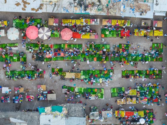 April 25, 2026, Ahmedabad, Gujarat, India: An aerial view captures the vibrant activity of a crowded vegetable market in Ahmedabad, India, on April 25, 2026, as vendors arrange fresh produce and customers move through narrow market lanes. The colorful stalls filled with seasonal vegetables highlight the importance of local trade and daily commerce, while steady consumer demand in 2026 continued to support growth in the cityÃ¢â‚¬â ¢s fresh produce market. Ahmedabad India  - ZUMAs263 20260425_zip_s263_002 Copyright: xSaurabhxSirohiyax