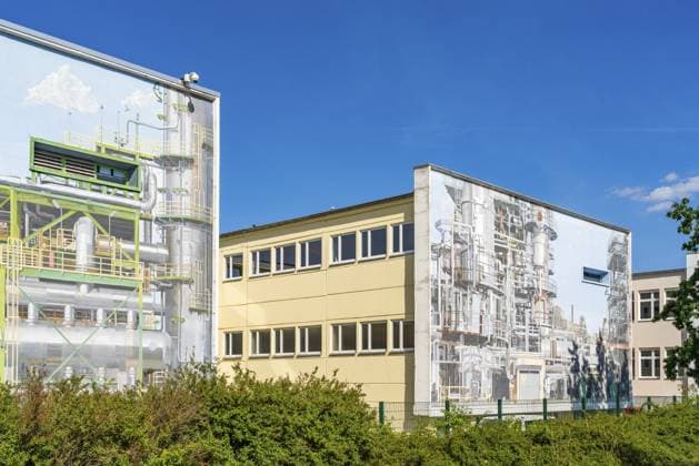 Gebäude der PCK Erdöl-Raffinerie Schwedt mit Graffiti, Streetart, längstes Fassadenbild Deutschlands mit Maschinen und Industrie-Motiven, Schwedt an der Oder, Uckermark, Brandenburg, Deutschland PCK Erdöl-Raffeinerie Schwedt building with graffiti, street art, Germany s longest façade with machinery and industrial motifs, Schwedt an der Oder, Uckermark, Brandenburg, Germany Copyright: imageBROKER OliverxGerhard ibloge17408827.jpg