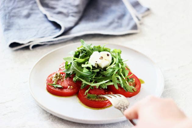 Caprese salad with tomatoes, arugula, mozzarella and pesto sauce Russia, Moscow Oblast, Russia R_CTOS260424-2004909-01