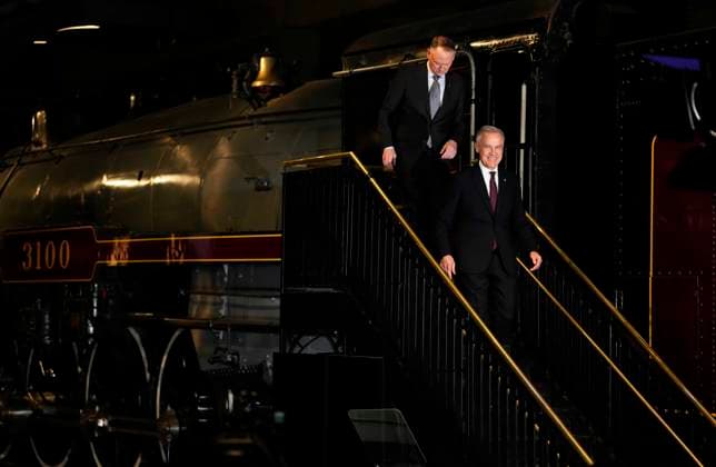 April 27, 2026, Ottawa, On, CANADA: Prime Minister Mark Carney steps down from a Canadian Pacific locomotive at the Canada Science and Technology Museum, as he arrives with Minister of National Defence David McGuinty to make an announcement on the Canada Strong Fund, Canada s first sovereign wealth fund in Ottawa on Monday, April 27, 2026. Ottawa CANADA  - ZUMAc35_ 20260427_zaf_c35_014 Copyright: xJustinxTangx