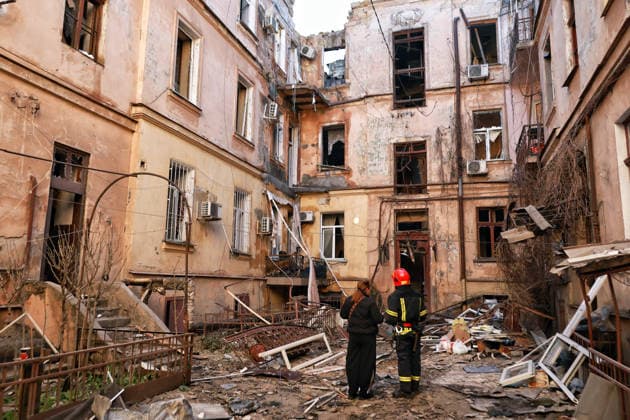 A rescuer and a woman stand in the courtyard of an apartment block damaged by a Russian drone attack in Odesa, Ukraine, April 27, 2026. The Russian army once again struck residential areas and civilian infrastructure in the southern city, with the heaviest damage recorded in the Prymorskyi district. Ten people, including two children, required medical assistance. (Photo by Nina Liashonok Ukrinform) Russian army attacks residential areas, civil infrastructure in Odesa  Copyright: xNinaxLiashonokx