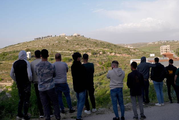 Palestinians evacuate home after Israeli Settler attack in West Bank WEST BANK, PALESTINE - APRIL 27: Israeli forces prevent local residents from approaching a house that had been set on fire Israeli settlers in the village of Jalud, south of Nablus, in West Bank, Palestine on April 27, 2026. According to local sources, dozens of settlers, under the protection of Israeli soldiers, stormed the village and attacked residents and their property with stones and Molotov cocktails, setting fires to homes and vehicles. Issam Rimawi Anadolu Nablus West Bank. Editorial use only. Please get in touch for any other usage.  Copyright: x2026xAnadoluxIssamxRimawix