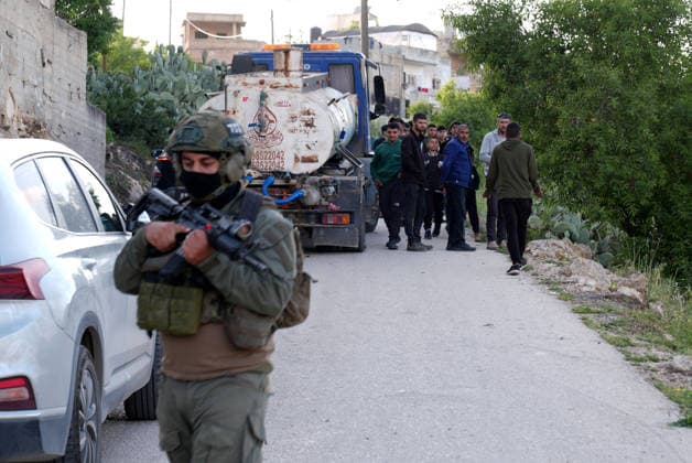 Palestinians evacuate home after Israeli Settler attack in West Bank WEST BANK, PALESTINE - APRIL 27: Israeli forces prevent local residents from approaching a house that had been set on fire Israeli settlers in the village of Jalud, south of Nablus, in West Bank, Palestine on April 27, 2026. According to local sources, dozens of settlers, under the protection of Israeli soldiers, stormed the village and attacked residents and their property with stones and Molotov cocktails, setting fires to homes and vehicles. Issam Rimawi Anadolu Nablus West Bank. Editorial use only. Please get in touch for any other usage.  Copyright: x2026xAnadoluxIssamxRimawix