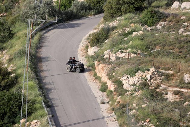 Palestinians evacuate home after Israeli Settler attack in West Bank WEST BANK, PALESTINE - APRIL 27: Israeli settlers ride an ATV in the village of Jalud, south of Nablus, in West Bank, Palestine on April 27, 2026. A group of settlers, under the protection of Israeli soldiers, attacked Palestinians and their homes with stones and Molotov cocktails, leading to property damage and the evacuation of usable items from affected houses. Issam Rimawi Anadolu Nablus West Bank. Editorial use only. Please get in touch for any other usage.  Copyright: x2026xAnadoluxIssamxRimawix