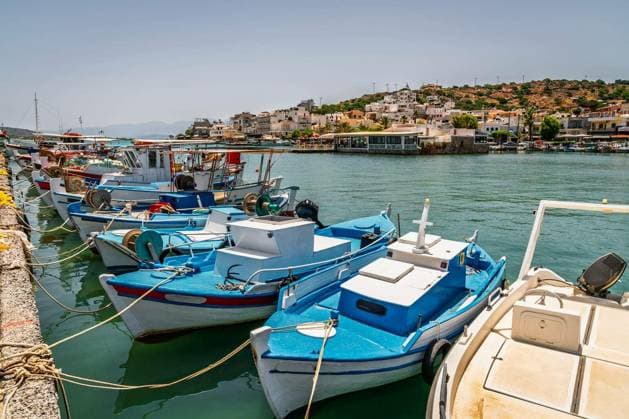 Fishing boats docked at a pier in a small town of Elounda on Crete, Greece Copyright: xalexeysx Panthermedia102453852.jpg