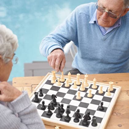 Passing the time with an engrossing game of chess. An elderly couple playing a game of chess (License=RF) ,model released, Symbolfoto  Copyright: xZoonar.com YurixArcursx 19637652 ,model released, Symbolfoto ,property released