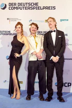 Katrin Bauerfeind, Gast und Uke Bosse bei der Verleihung des Deutschen Computerspielpreises 2026 im Herkulessaal der Residenz. München, 29.04.2026