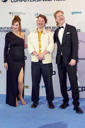 Katrin Bauerfeind, Gast und Uke Bosse bei der Verleihung des Deutschen Computerspielpreises 2026 im Herkulessaal der Residenz. München, 29.04.2026