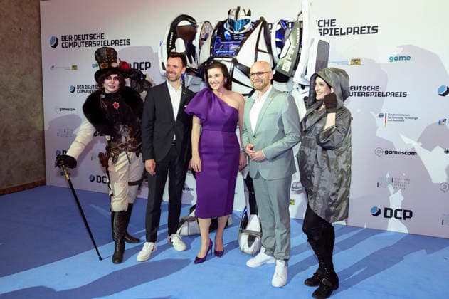 Felix Falk, Dorothee Bär und Fabian Mehring bei der Verleihung des Deutschen Computerspielpreises 2026 im Herkulessaal der Residenz. München, 29.04.2026