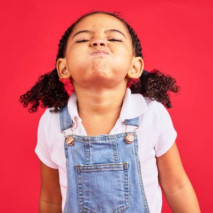 Attitude, childhood and face of girl on red background in studio with angry, upset and frustrated reaction. Emoji, comic and young kid with air in cheeks, tantrum behaviour and mad facial expression. (License=RF) ,model released, Symbolfoto  Copyright: xZoonar.com YurixArcursxpeopleimages.comx 19733373 ,model released, Symbolfoto ,property released
