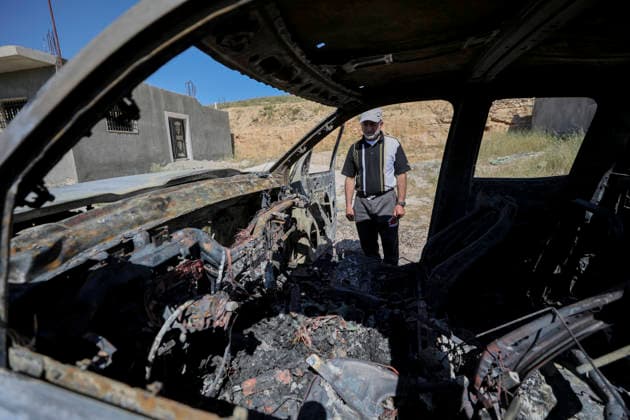 Burned Vehicle Hebron West Bank A man stands next to the burned remains of a Palestinian vehicle in the Wadi al-Rakhim area of Susya village in Masafer Yatta, south of Hebron in the Israeli-occupied West Bank, on May 1, 2026. Local residents said settlers burned the vehicle and wrote anti-Arab slogans on nearby houses. Hebron West Bank Palestinian Territories Copyright: xMosabxShawerx