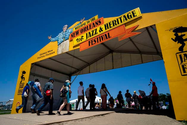 People arrive at the New Orleans Jazz and Heritage Festival at the Fairgrounds Race Courts and Slots in New Orleans, Louisiana on Sunday, May 3, 2026. Organizers expected about 400,000 to attend, but the finally tally, which won t be available for a few days, may be impacted by rain that interrupted festival operations Thursday and Friday.  NOL20260503302 BONNIExCASH