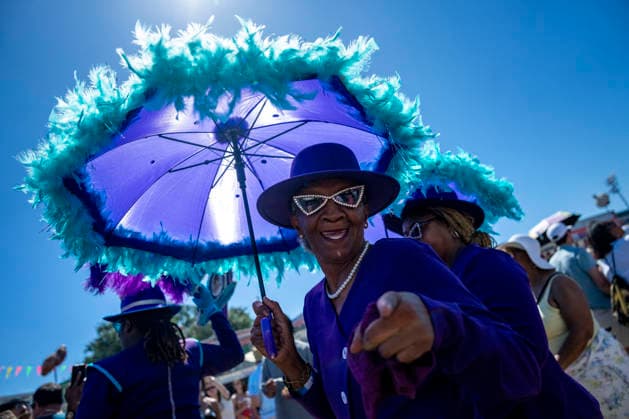 Members of the Zulu Social Aid and Pleasure Club walking group parade through the New Orleans Jazz and Heritage Festival at the Fairgrounds Race Courts and Slots in New Orleans, Louisiana on Sunday, May 3, 2026. Organizers expected about 400,000 to attend, but the finally tally, which won t be available for a few days, may be impacted by rain that interrupted festival operations Thursday and Friday.  NOL20260503313 BONNIExCASH