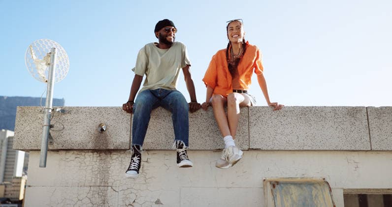 Rooftop, relax and friends for social conversation together in cool wind, sunshine and blue sky mock up space for advertising gen z youth aesthetic. Happy black people couple on urban city building. (License=RF) ,model released, Symbolfoto  Copyright: xZoonar.com YurixArcursxpeopleimages.comx 19872069 ,model released, Symbolfoto ,property released