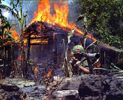RECORD DATE NOT STATED A photograph of Private First Class Raymond Rumpa at a burning Viet Cong base camp in Vietnam. A photograph of Private First Class Raymond Rumpa, of C Company, 3rd Battalion, 47th Infantry, 9th Infantry Division, wielding a 90mm recoilless rifle in front of a burning Viet Cong base camp in My Tho, Vietnam. This scene is indicative of the destructive search and destroy tactics employed by US forces during the Vietnam War to eliminate enemy infrastructure. 4 May 1968. Editorial use only. All other uses to be cleared with the copyright owner (World History Archive), in advance., WHA_011_0255.jpg, Raymond Rumpa; Vietnam War; My Tho; Viet Cong; US forces; 9th Infantry Division; 47th Infantry Regiment; 90mm recoilless rif Copyright: xx