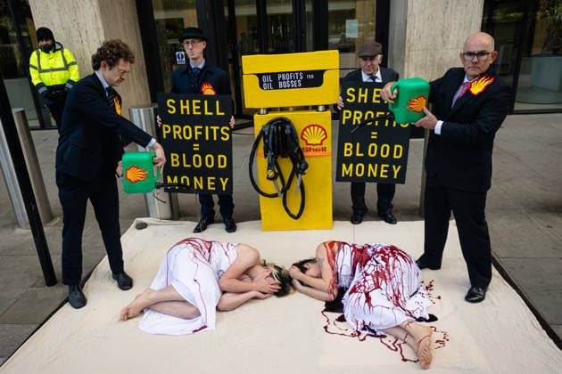 Climate Activists Pour Fake Blood over Protesters at Mock Petrol Pump outside Shell Centre, London, UK 6 May 2026 Activists lie on the ground in front of a mock petrol pump reading Oil Profit$$$ for Oil Bo$$es as they are doused in red liquid resembling blood outside the Shell Centre, London, UK, on 6 May 2026, during a Fossil Free London protest targeting Shell ahead of an expected jump in quarterly profits amid the US-Iran conflict., Credit:Pete Speller Avalon London, United Kingdom  Copyright: xPetexSpellerx xAvalonx 1096871559