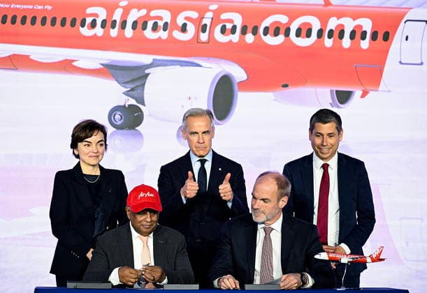 May 6, 2026, Mirabel, Pq, Canada: Quebec Premier Christine Frechette, back left, Prime Minister Mark Carney, centre, and Guillaume Chevasson, CEO, Airbus Canada, back right, look on as Lars Wagner, CEO, Airbus Commercial Aircraft, front right, and AirAsia CEO Tony Fernandes, front left, sign a landmark order for 150 Airbus A220 aircraft during an event at the Airbus A220 Delivery Center in Mirabel, Que., Wednesday, May 6, 2026. Mirabel Canada - ZUMAc35_ 20260506_zaf_c35_173 Copyright: xGrahamxHughesx