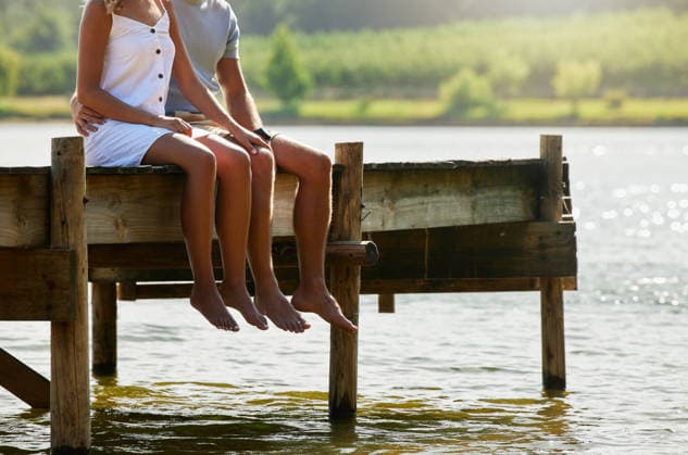 Couple together in nature, relax by lake and summer, travel and adventure, love and care outdoor. People in relationship, trust and bonding on vacation, man and woman sitting on jetty with freedom. (License=RF) ,model released, Symbolfoto  Copyright: xZoonar.com YurixArcursxpeopleimages.comx 20038567 ,model released, Symbolfoto ,property released