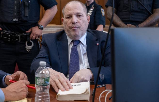 Former Hollywood film producer Harvey Weinstein appears in Manhattan criminal court for the retrial of his rape case on Thursday, May 7, 2026, in New York City. Weinstein, the disgraced former Hollywood producer, will be tried for a third time by New York prosecutors in the sexual assault case of Jessica Mann. The memoir Arsenio sits on the table in front of Weinstein. Pool  NYX20260507203 SpencerxPlatt