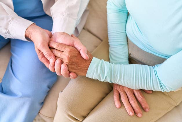 Senior healthcare support ? a compassionate nurse gently holds the hand of an elderly patient, offering comfort and medical assistance. (License=RF) ,model released, Symbolfoto  Copyright: xZoonar.com RobertxKneschkex 25011581 ,model released, Symbolfoto ,property released