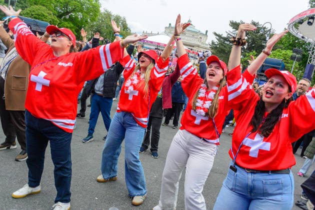 vienna, austria, 15 may 2026, esc village in front of the city hall, eurovision song contest, swiss fans dancing to the song ymca by village people