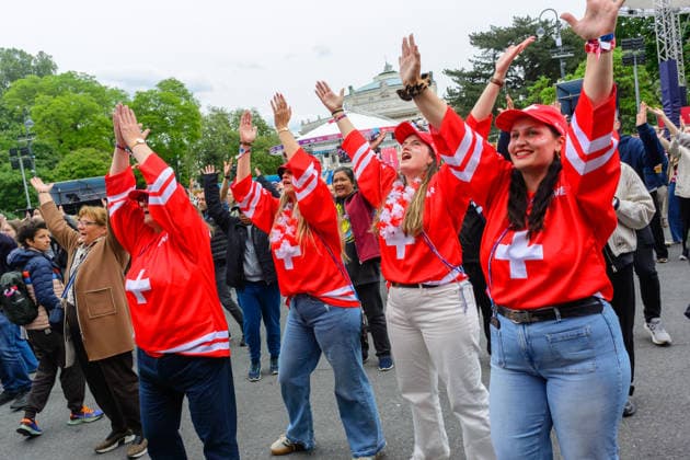 vienna, austria, 15 may 2026, esc village in front of the city hall, eurovision song contest, swiss fans dancing to the song ymca by village people