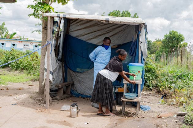 (260517) -- RWAMPARA, May 17, 2026 () -- A health worker instructs a local resident to wash hands at the general reference hospital in Rwampara in eastern Democratic Republic of the Congo, on May 16, 2026. The death toll from the latest Ebola outbreak in the Democratic Republic of the Congo (DRC) has risen to 87, the Africa Centers for Disease Control and Prevention (Africa CDC) said Saturday, warning that the outbreak is driven by the Bundibugyo strain, for which no strain-specific vaccine is currently available, and that it carries a high risk of regional spread. (Str ) DR CONGO-RWAMPARA-EBOLA OUTBREAK-HOSPITAL Xinhua 