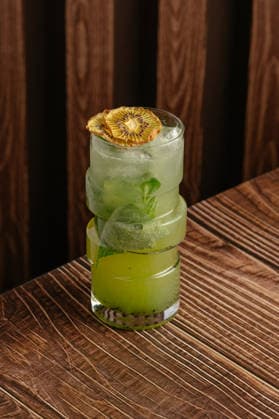 Modern green cocktail with a dried kiwi garnish R_KUAL260517-2031163-01
