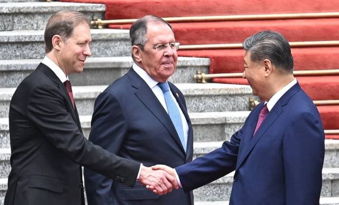 China Russia 9169380 20.05.2026 Chinese President Xi Jinping shakse hands with Russian First Deputy Prime Minister Denis Manturov alongside Russian Foreign Minister Sergey Lavrov during a welcome ceremony for Russian President Vladimir Putin outside the Great Hall of the People in Beijing, China. Kristina Solovyova Sputnik Beijing China  Copyright: xKristinaxSolovyovax